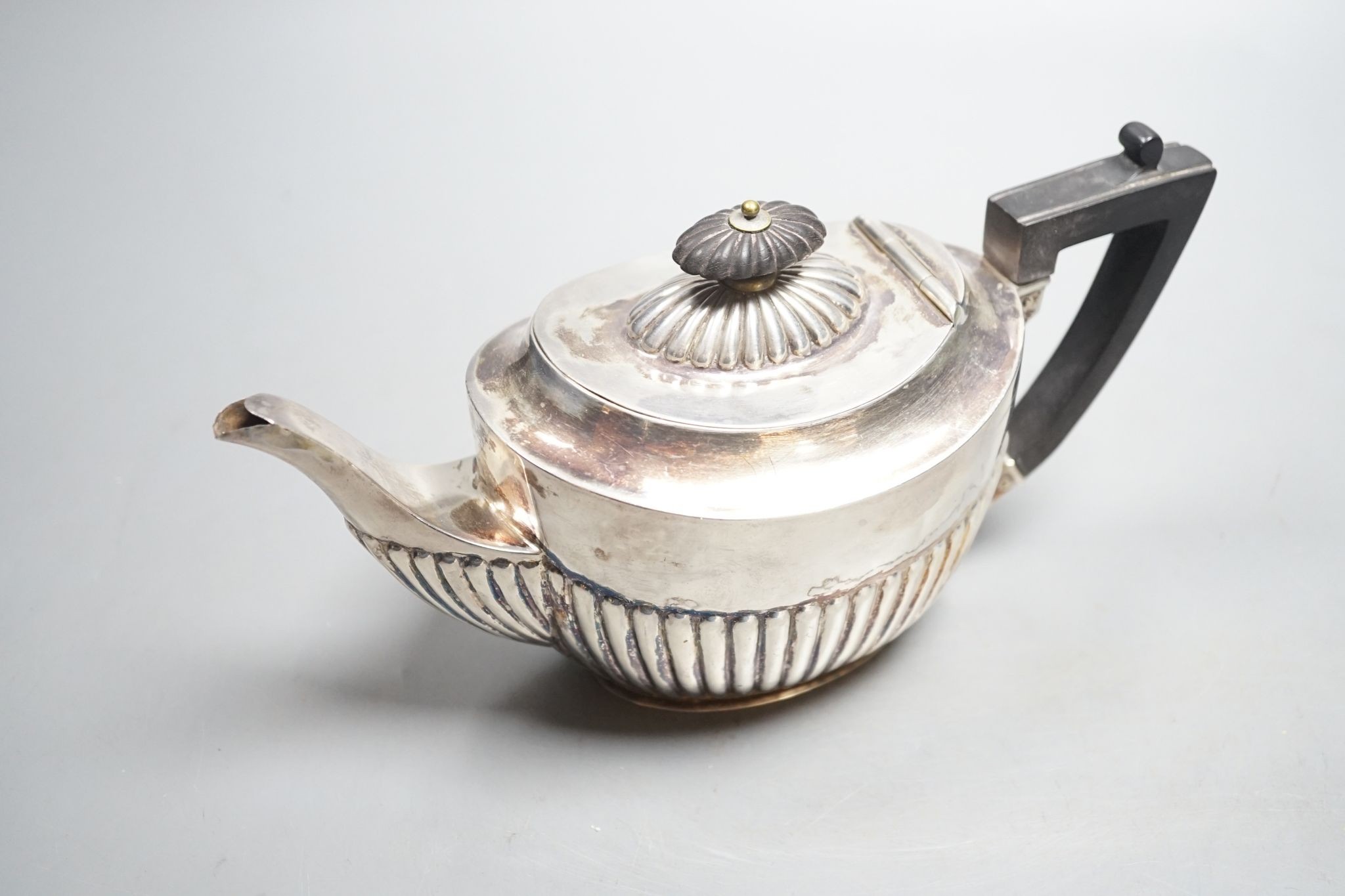 A late Victorian demi- fluted silver teapot, Sheffield, 1896, 8oz.